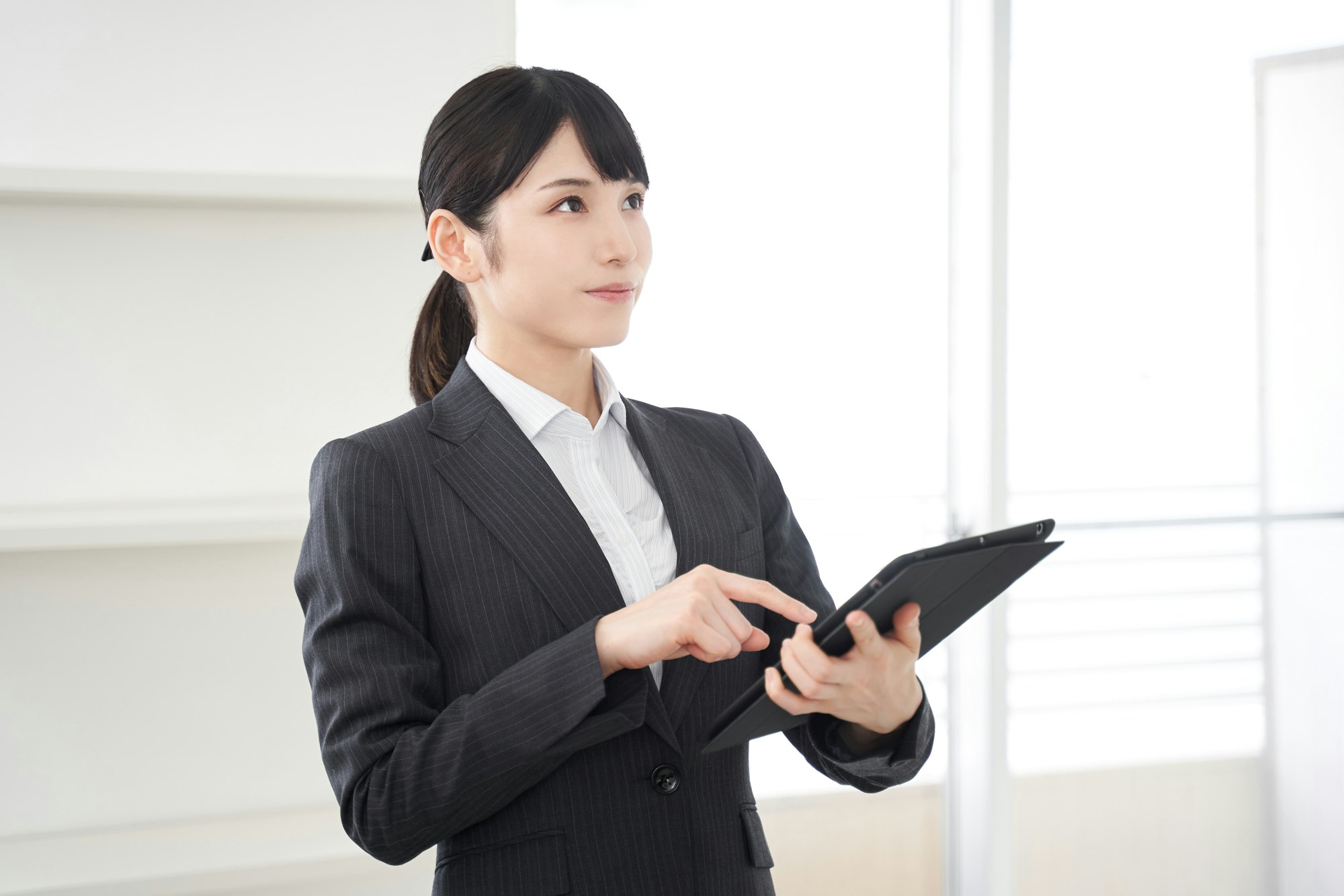 Japanese female real estate appraiser checking out a house